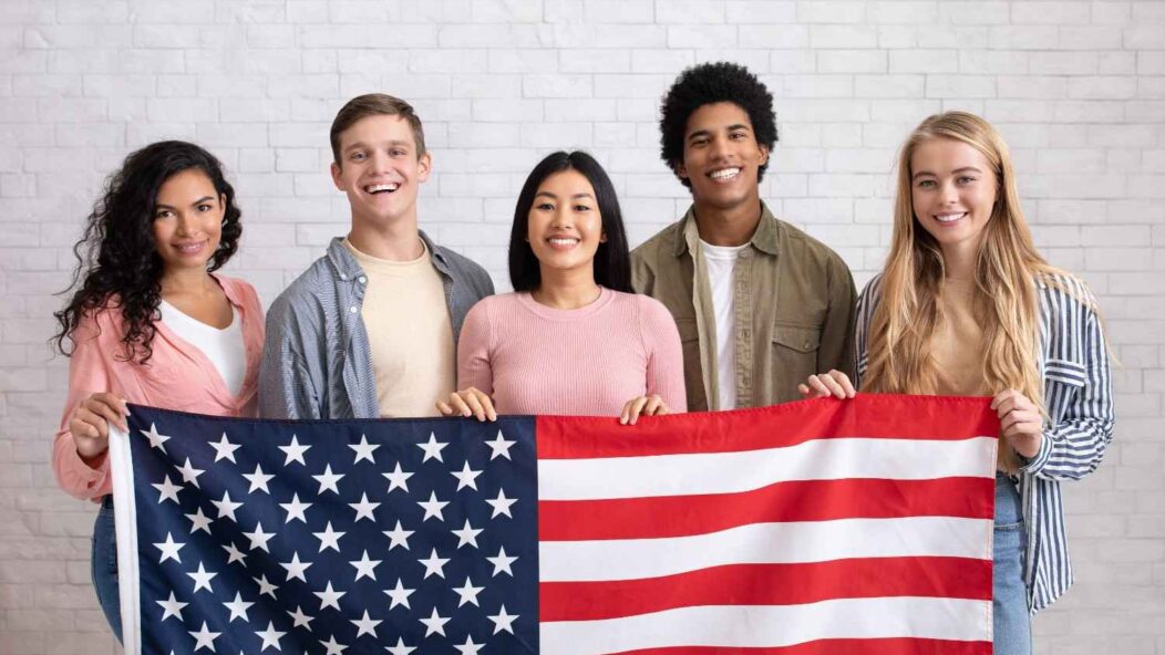 Diversity Visa Lottery winners holding U.S. flag – Green Card Lottery program for immigrants to gain permanent residency in the United States