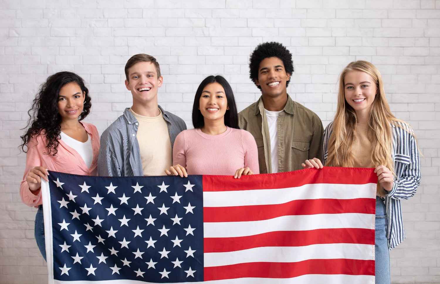Diversity Visa Lottery winners holding U.S. flag – Green Card Lottery program for immigrants to gain permanent residency in the United States