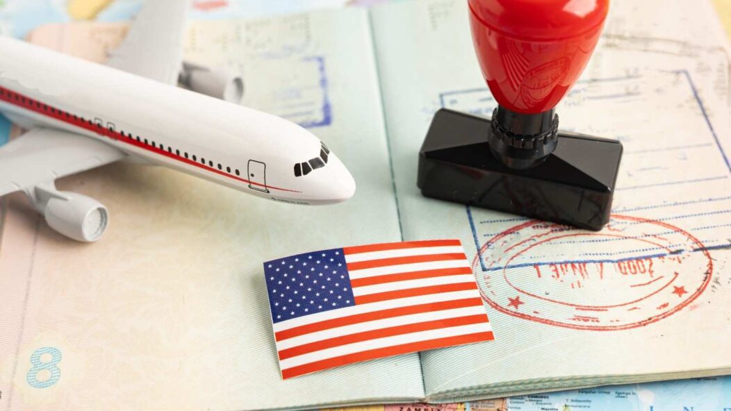 Expired green card travel documents with passport and US entry stamp representing re-entry to the United States