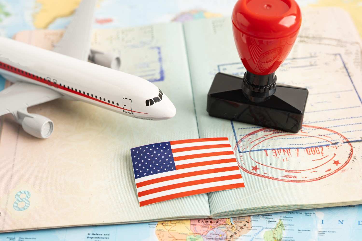 Expired green card travel documents with passport and US entry stamp representing re-entry to the United States