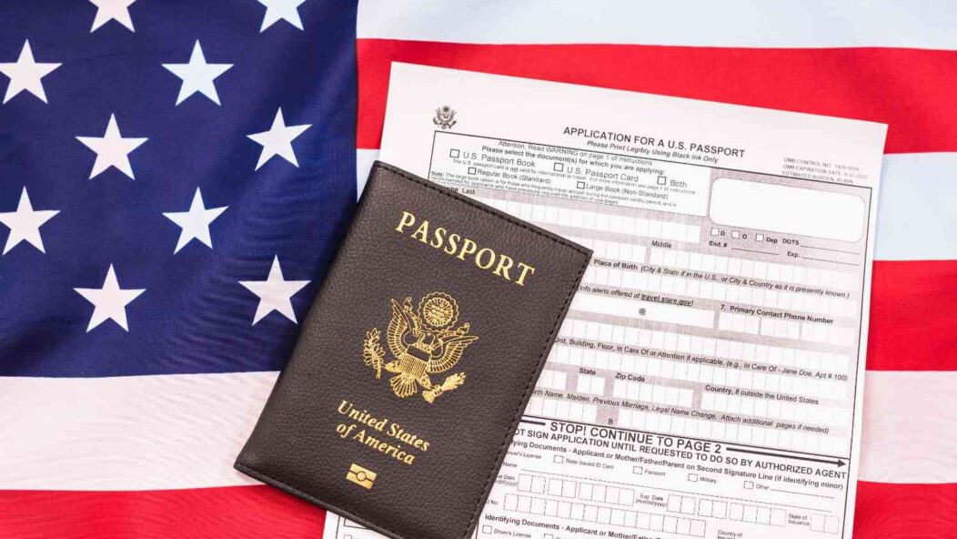 H-1B visa passport with U.S. flag and immigration application form – USCIS guidance for H-1B workers and green card process