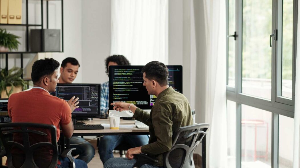 H-1B visa workers in office meeting discussing employment compliance and employer fraud risks in the United States