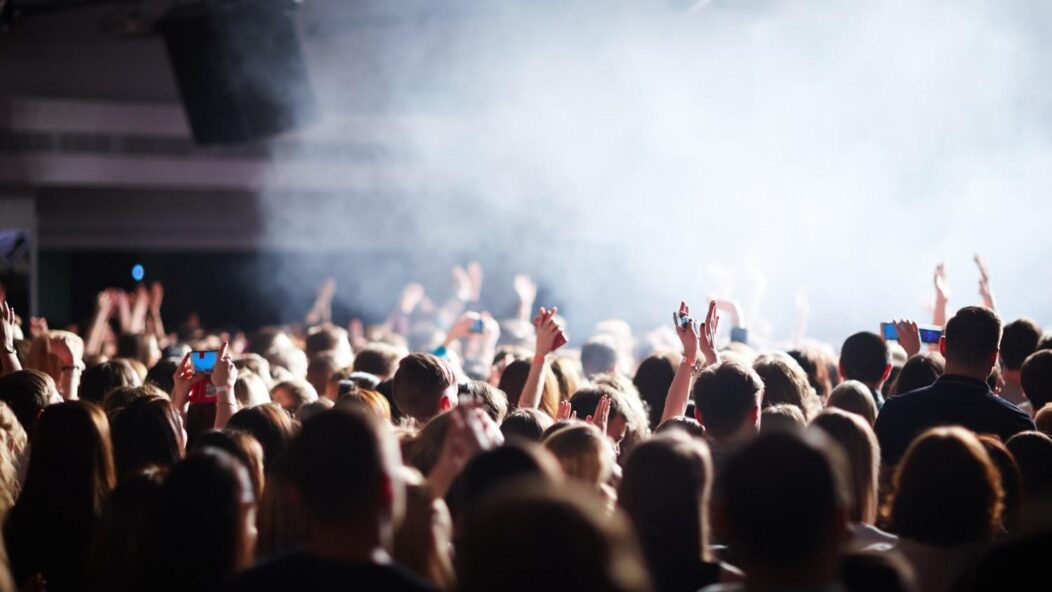 Crowd representing workforce uncertainty during company sale – impact on H1B employees and job security