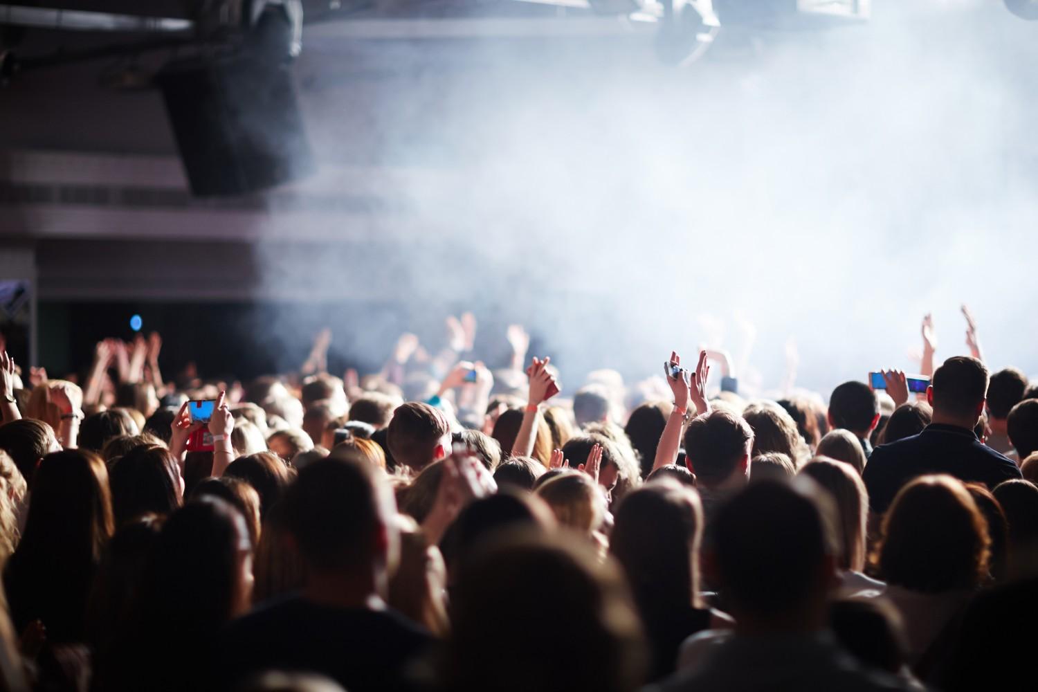 Crowd representing workforce uncertainty during company sale – impact on H1B employees and job security