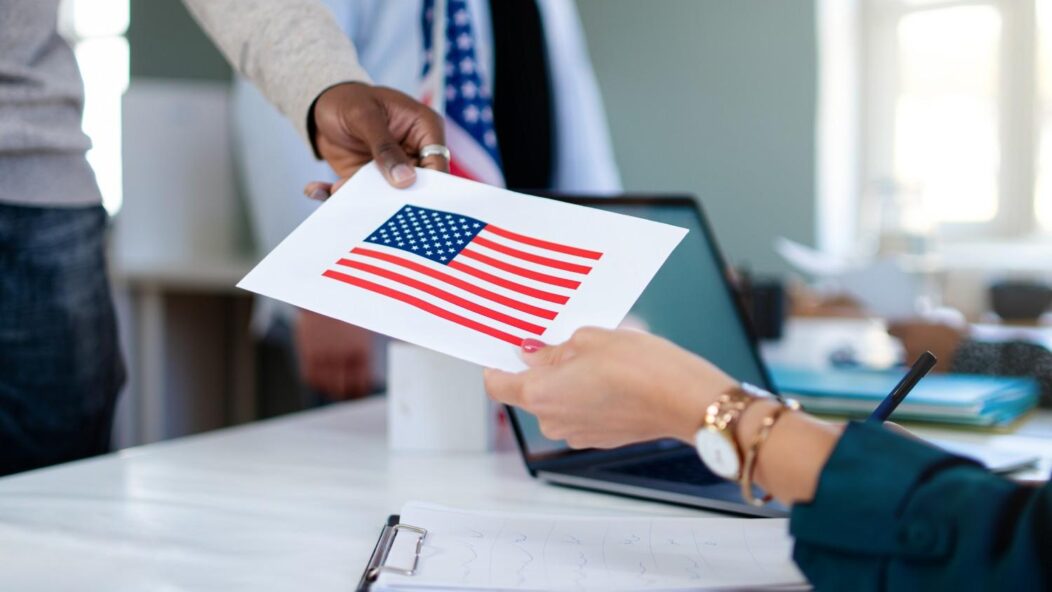 USCIS officer reviewing immigration documents during fraud investigation site visit at workplace