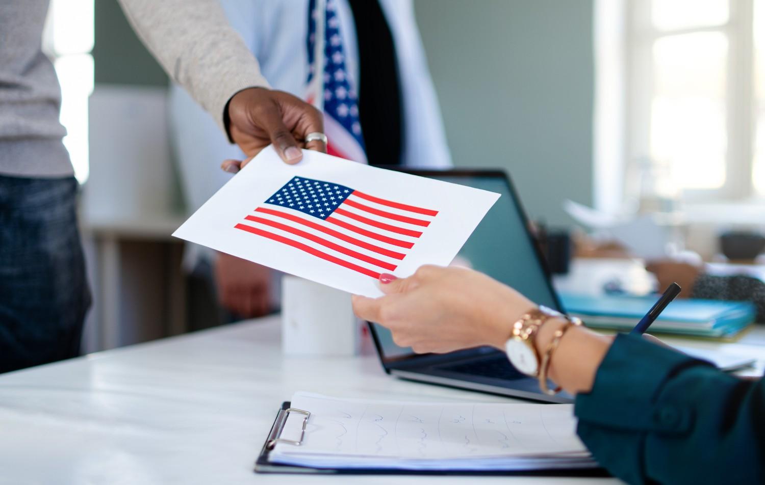 USCIS officer reviewing immigration documents during fraud investigation site visit at workplace