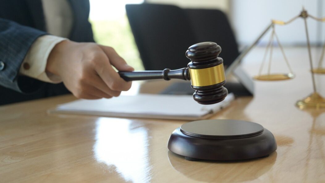 Judge holding gavel symbolizing court ruling on H-1B spouse work permit authorization