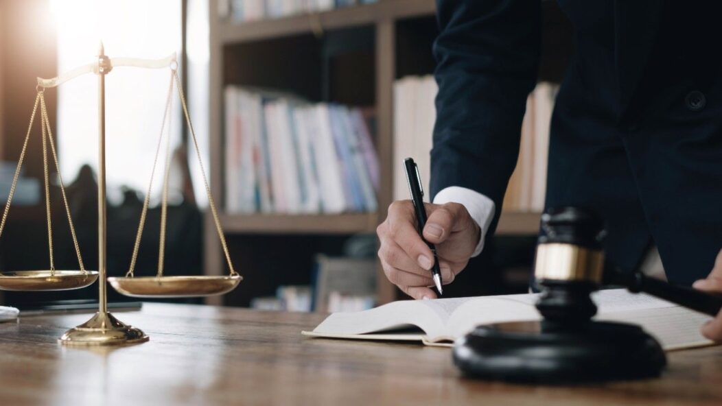 Immigration attorney reviewing visa case files with scales of justice and gavel for 221(g) litigation process