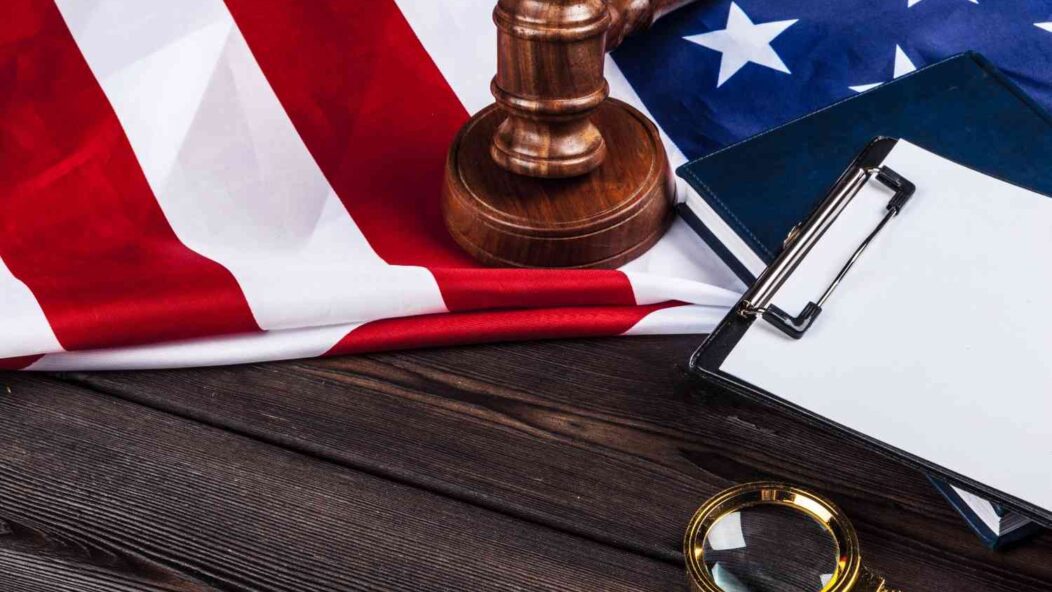Judge gavel with clipboard and U.S. flag symbolizing new H-1B visa regulations and immigration policy review