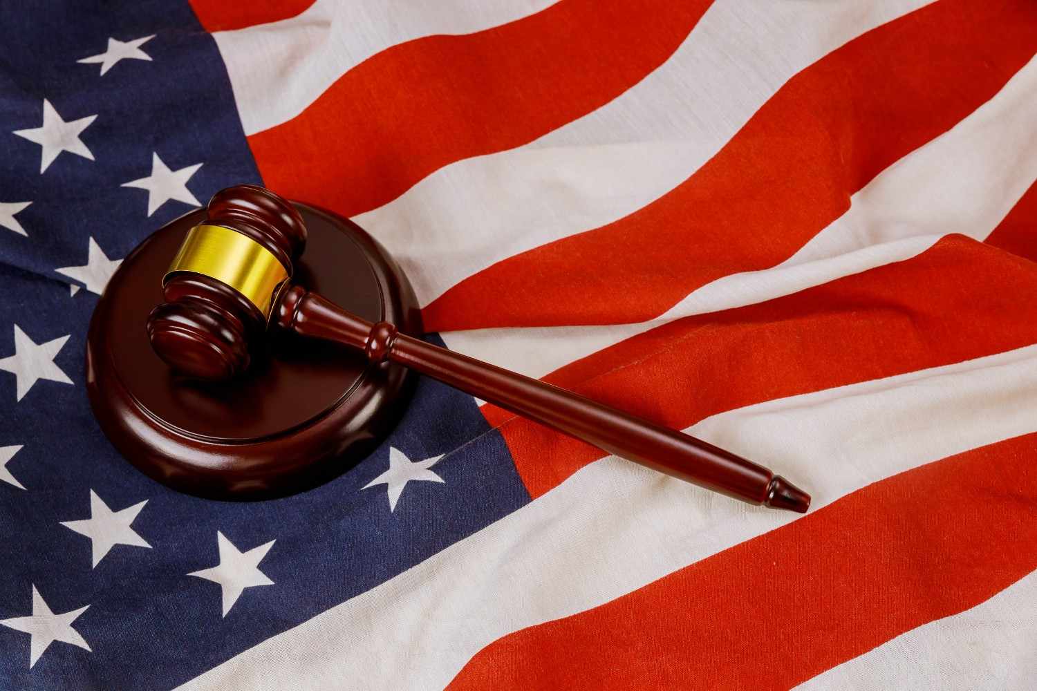 Judge gavel on United States flag symbolizing H-1B visa lottery legal process and immigration regulations