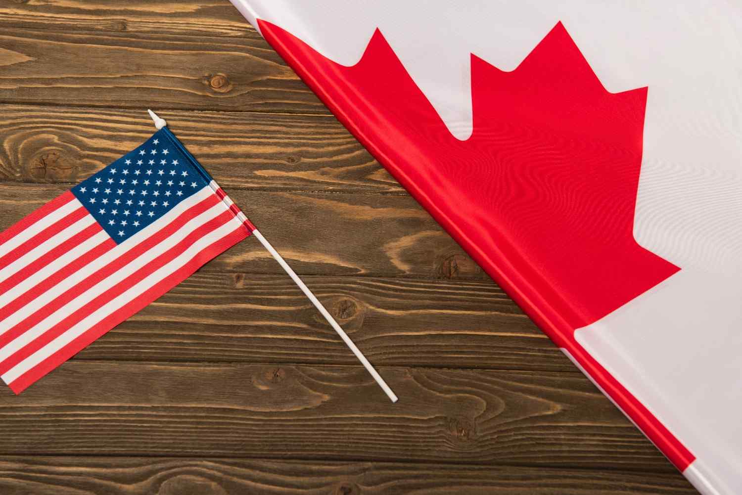 U.S. and Canada flags representing northern border migration and immigration policy issues