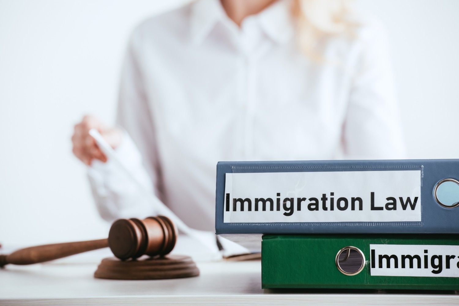 Immigration law files and legal gavel representing U.S. immigration reforms under Public Law 100-525