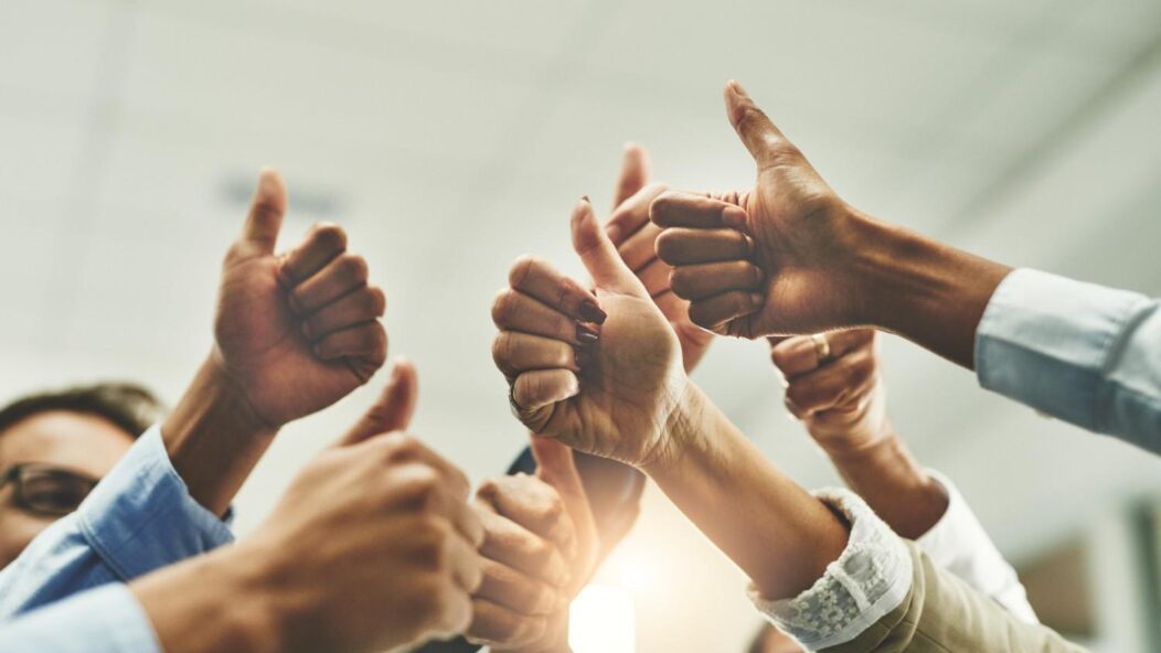 Team celebrating success symbolizing extraordinary achievement for EB-1 visa eligibility