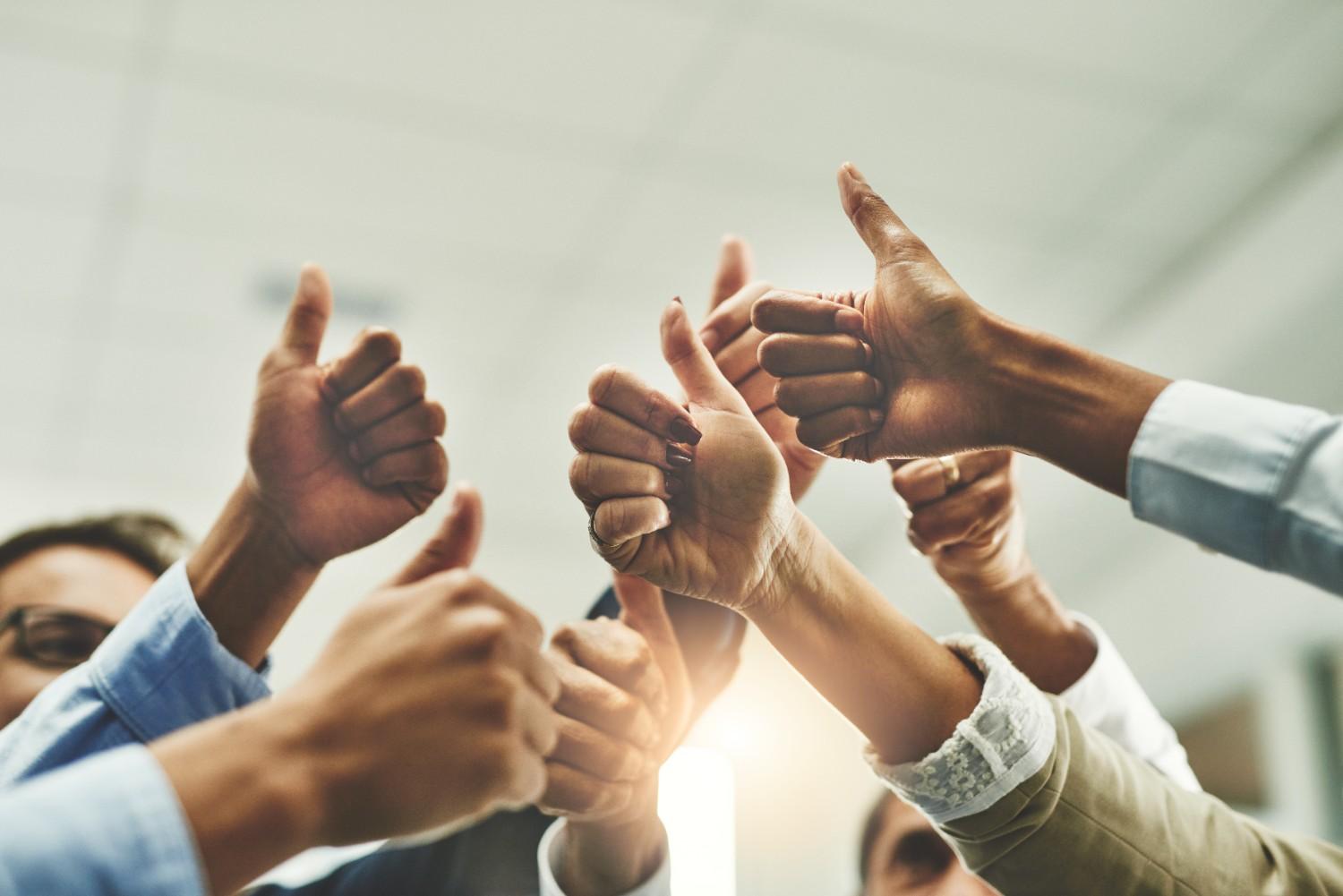 Team celebrating success symbolizing extraordinary achievement for EB-1 visa eligibility