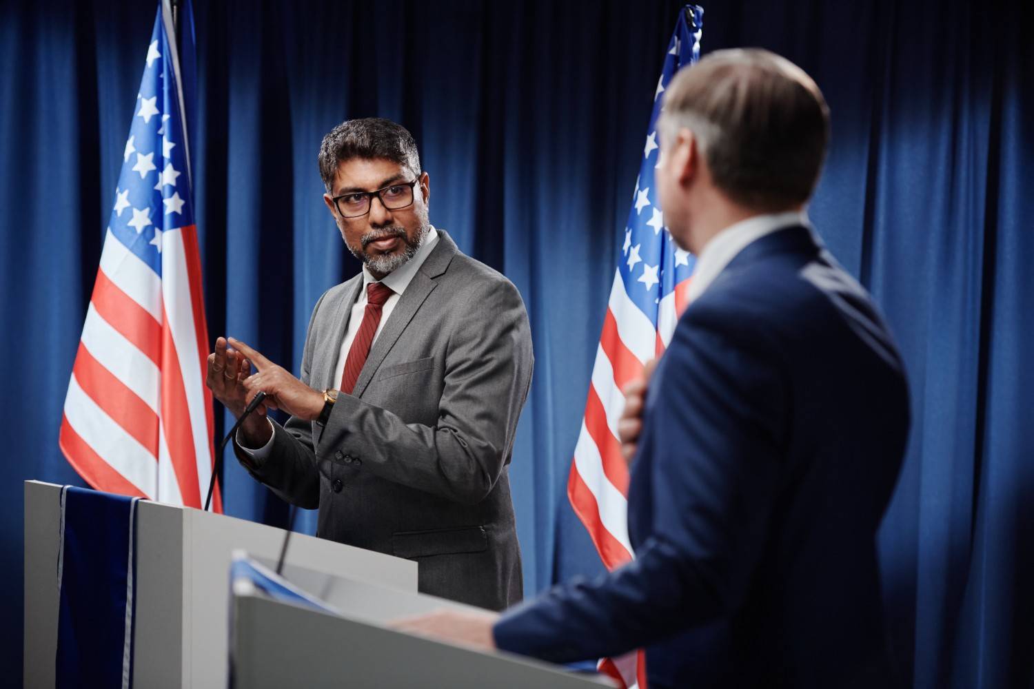 USCIS naturalization ceremony in Nevada, featuring attendees pledging allegiance with flags displayed, symbolizing U.S. citizenship process.