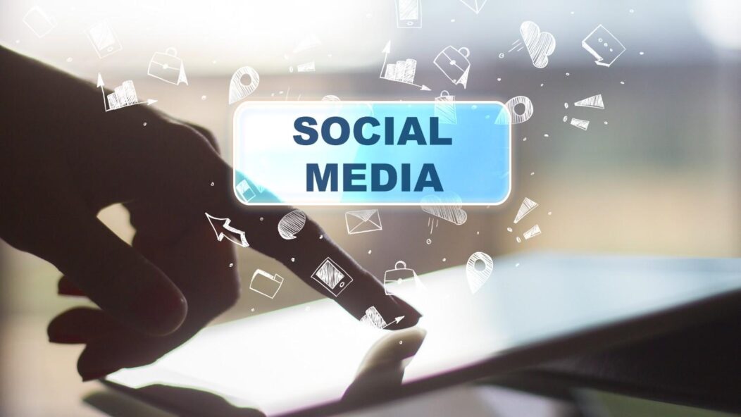 Person holding a smartphone displaying the word 'Social,' symbolizing the use of social media for immigration fraud detection by FDNS.