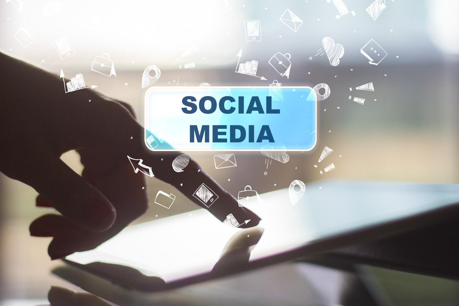 Person holding a smartphone displaying the word 'Social,' symbolizing the use of social media for immigration fraud detection by FDNS.