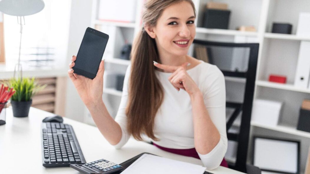 A professional man in an office holding a clipboard with charts and a notebook, expressing frustration, symbolizing challenges in navigating complex processes such as EB-1 visa applications.
