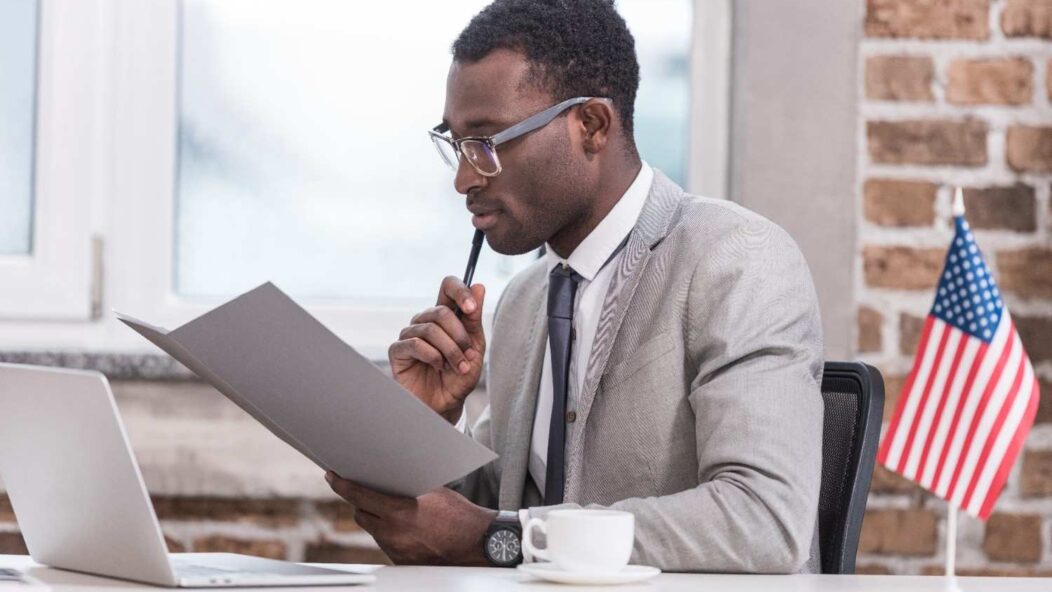 Professional woman holding a yellow star-shaped sign, emphasizing the 540-day EAD extension for seamless work authorization renewals.