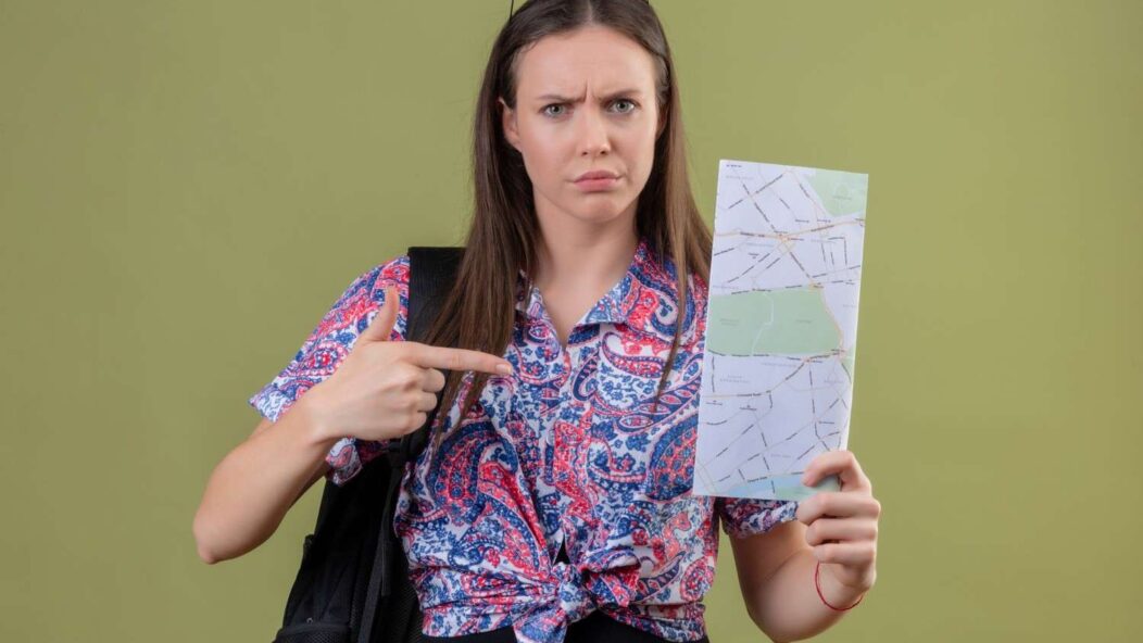 Concerned traveler pointing at a map, symbolizing confusion about U.S. visa overstay rules and its consequences.