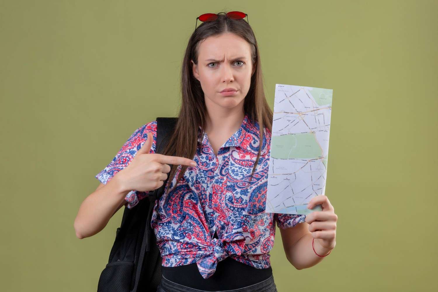Concerned traveler pointing at a map, symbolizing confusion about U.S. visa overstay rules and its consequences.