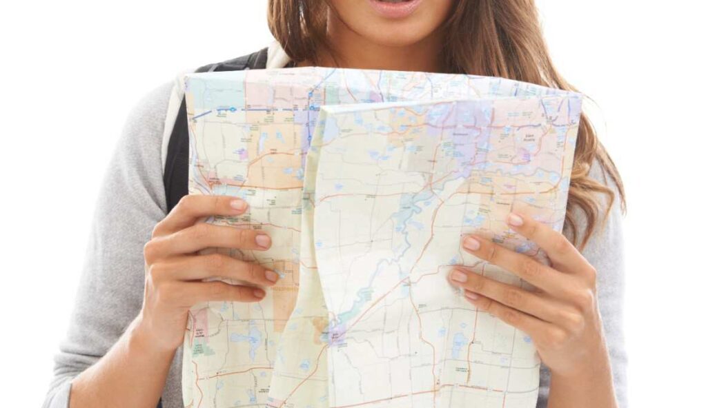 Concerned traveler pointing at a map, symbolizing confusion about U.S. visa overstay rules and its consequences.