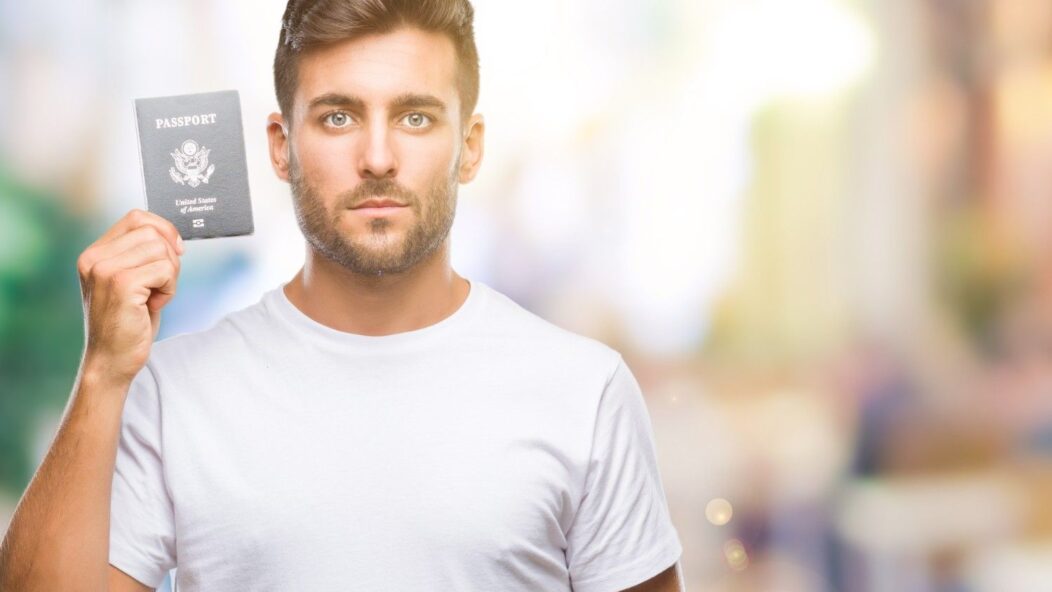 Man pointing to a blank clipboard, symbolizing the importance of filling Form I-129 correctly for USCIS compliance.