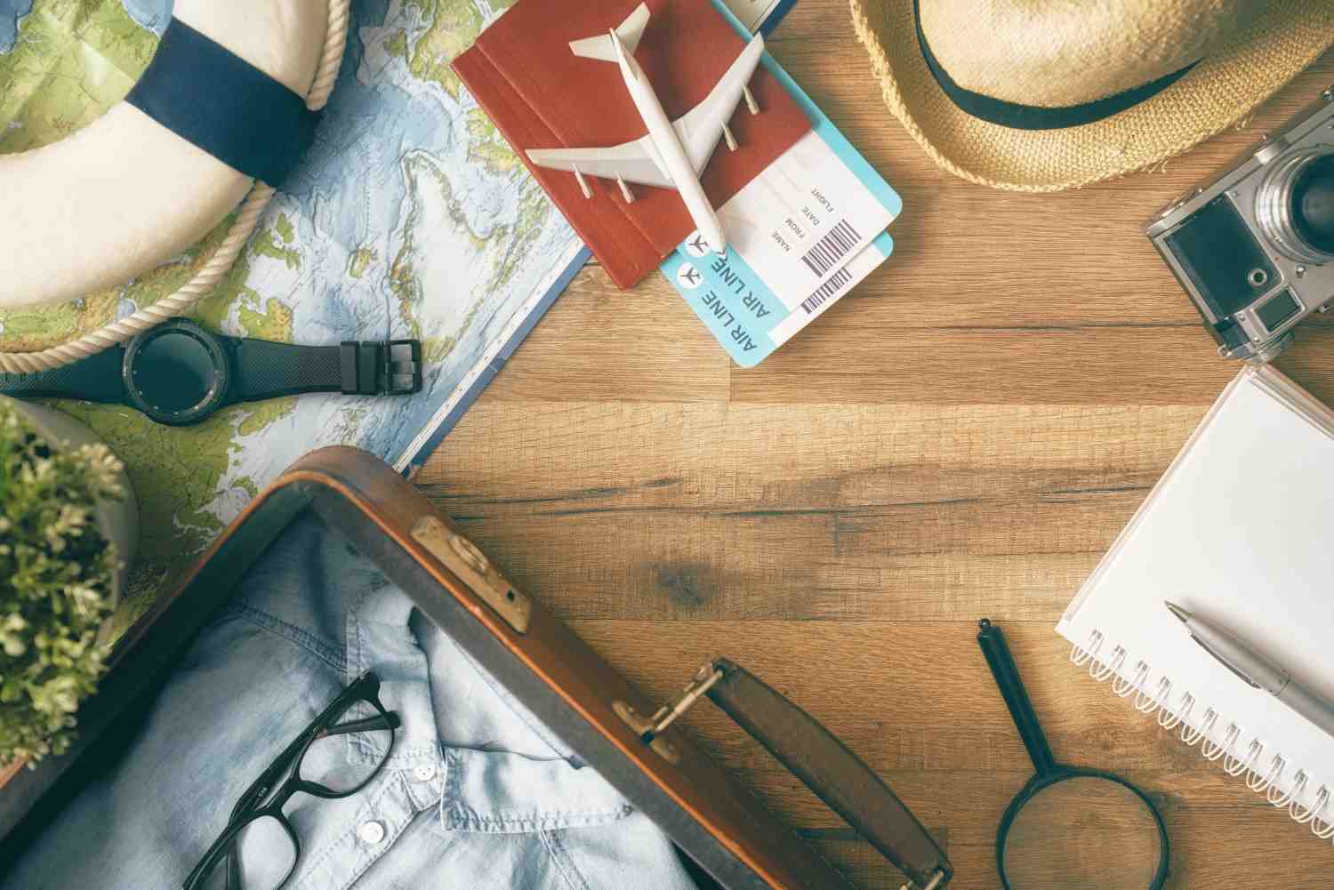 Travel essentials for handling visa revocations, including passports, maps, and magnifying glass for detailed immigration case research.