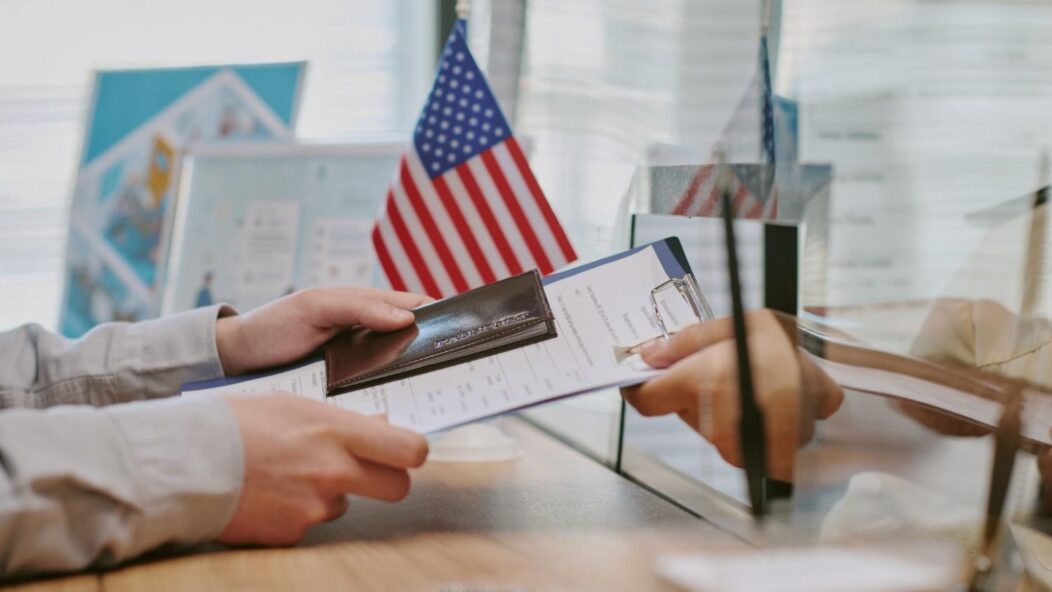 Young professional with a passport and travel bag, symbolizing TN Visa opportunities in 2025.