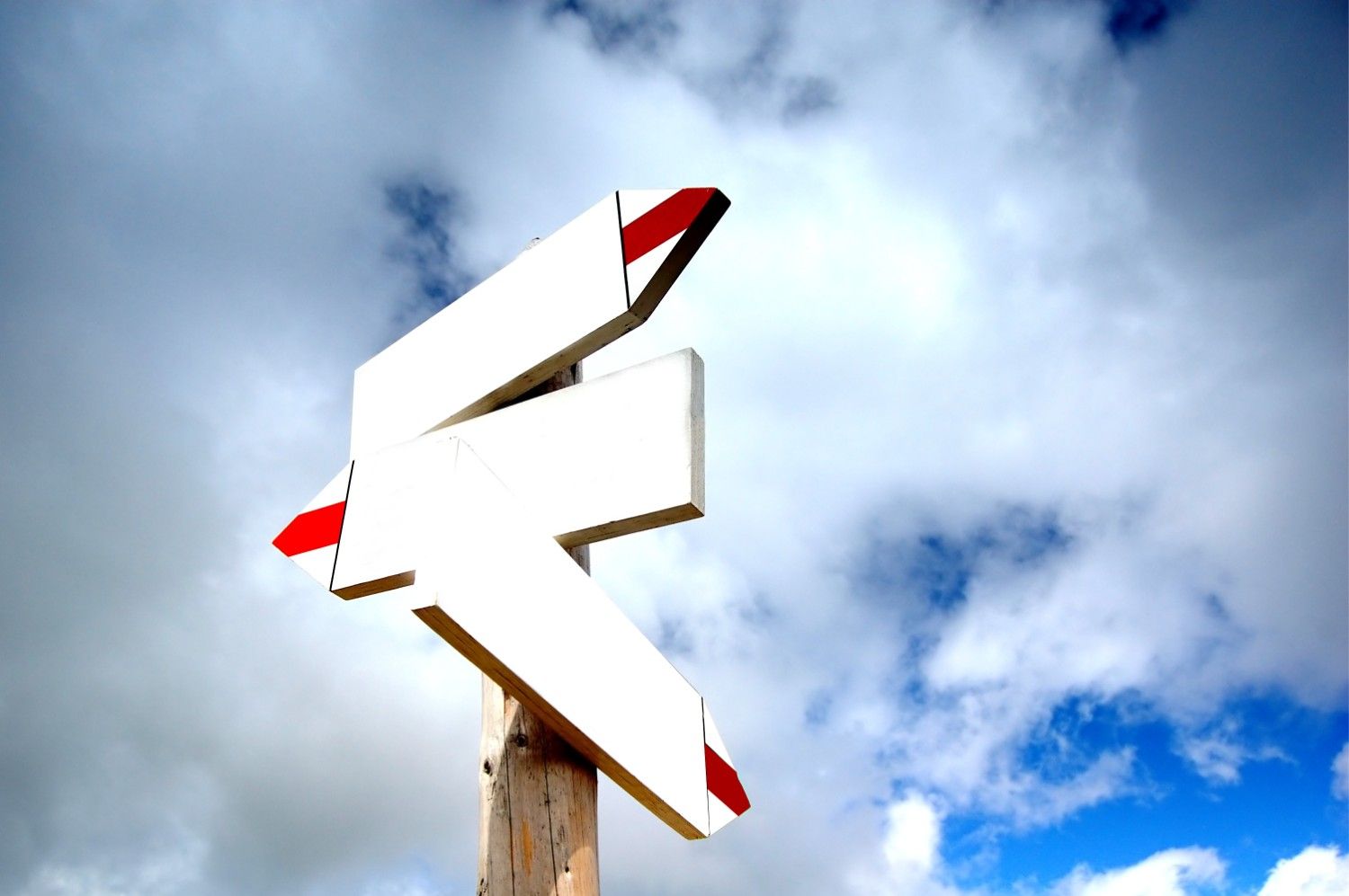 Signpost symbolizing changes in direction under a clear sky, representing the CBP One app impact on border entry processes.