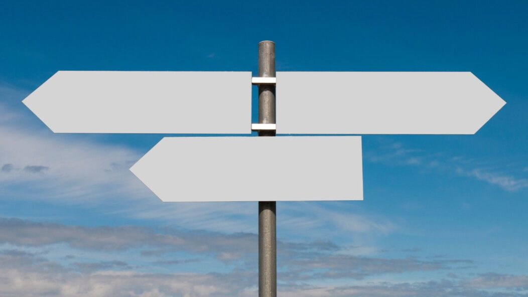 Signpost symbolizing changes in direction under a clear sky, representing the CBP One app impact on border entry processes.