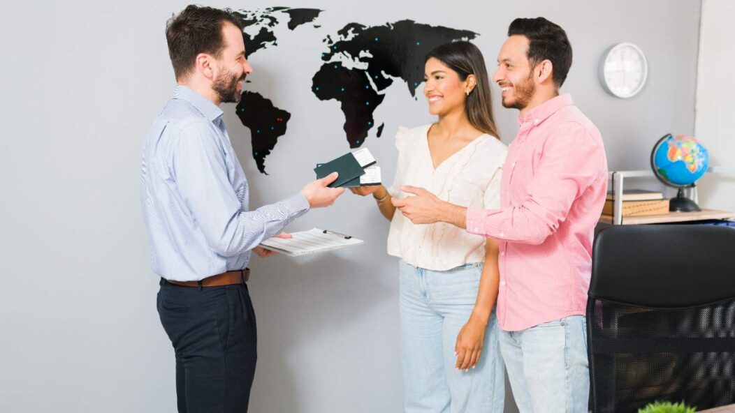 Employer discussing H-2B visa options with a foreign worker while pointing at a globe, symbolizing international workforce solutions.