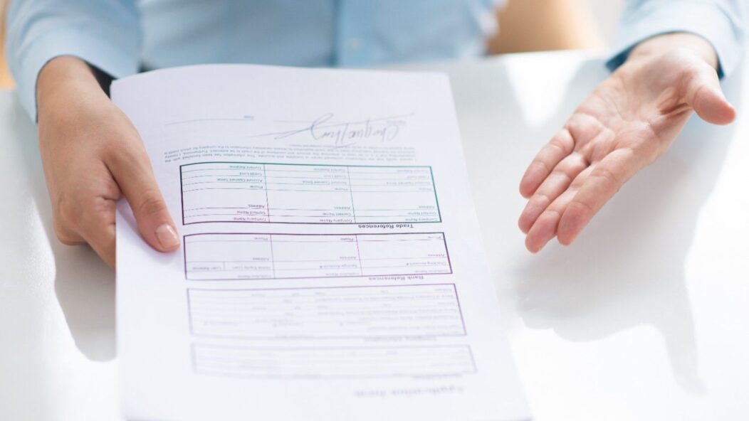 Person holding Form I-134A, which has been temporarily paused due to the 'Securing Our Borders' executive order, affecting immigration support.