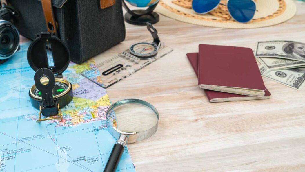 Travel essentials for handling visa revocations, including passports, maps, and magnifying glass for detailed immigration case research.