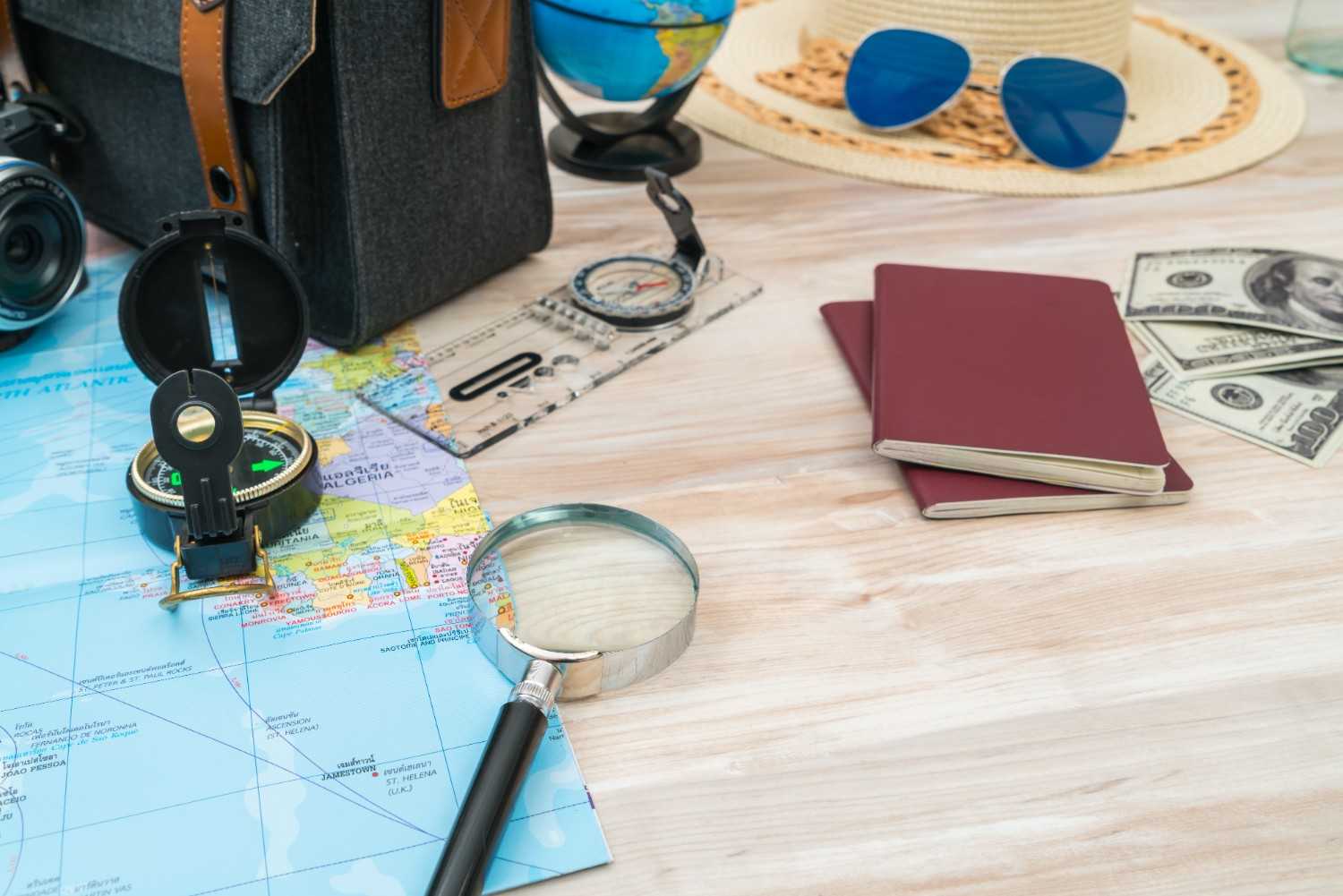 Travel essentials for handling visa revocations, including passports, maps, and magnifying glass for detailed immigration case research.