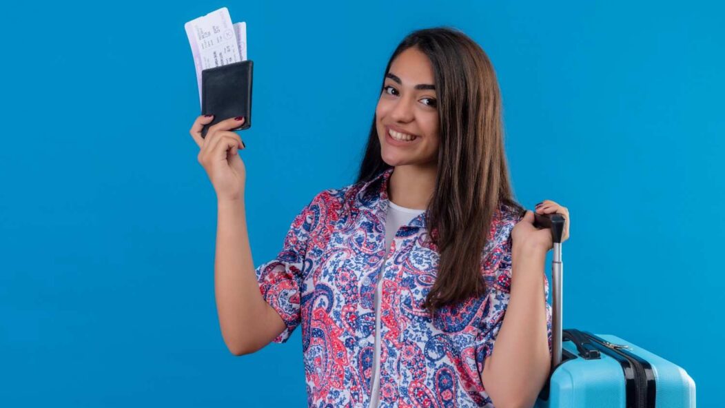 Young professional with a passport and travel bag, symbolizing TN Visa opportunities in 2025.