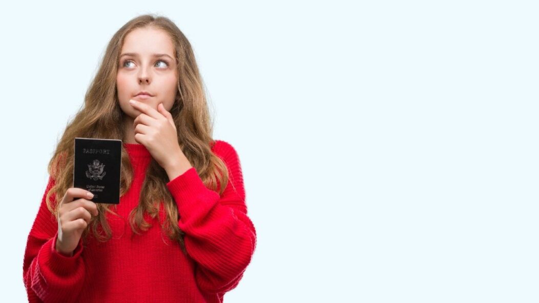 Professional holding travel documents and suitcase, symbolizing TN visa applicants navigating potential changes under Trump's policies in 2025.