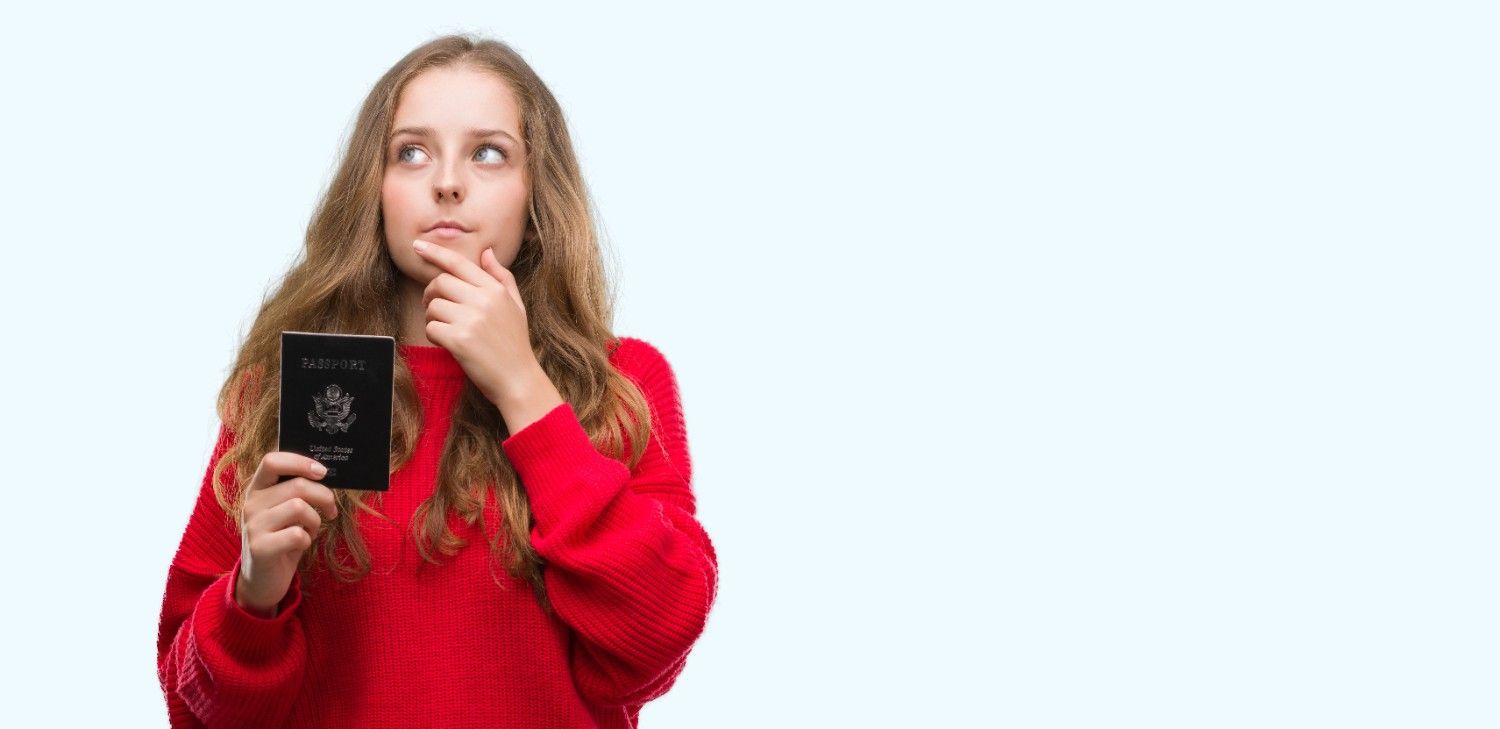 Professional holding travel documents and suitcase, symbolizing TN visa applicants navigating potential changes under Trump's policies in 2025.