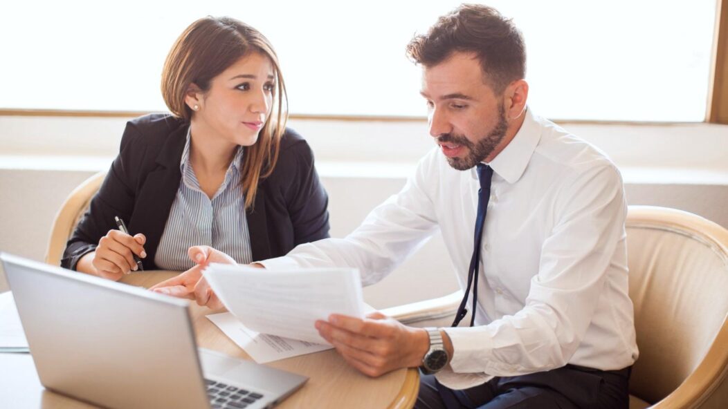 Immigration attorneys reviewing documents together in an office setting, highlighting the importance of legal strategies in securing U.S. visa approvals.