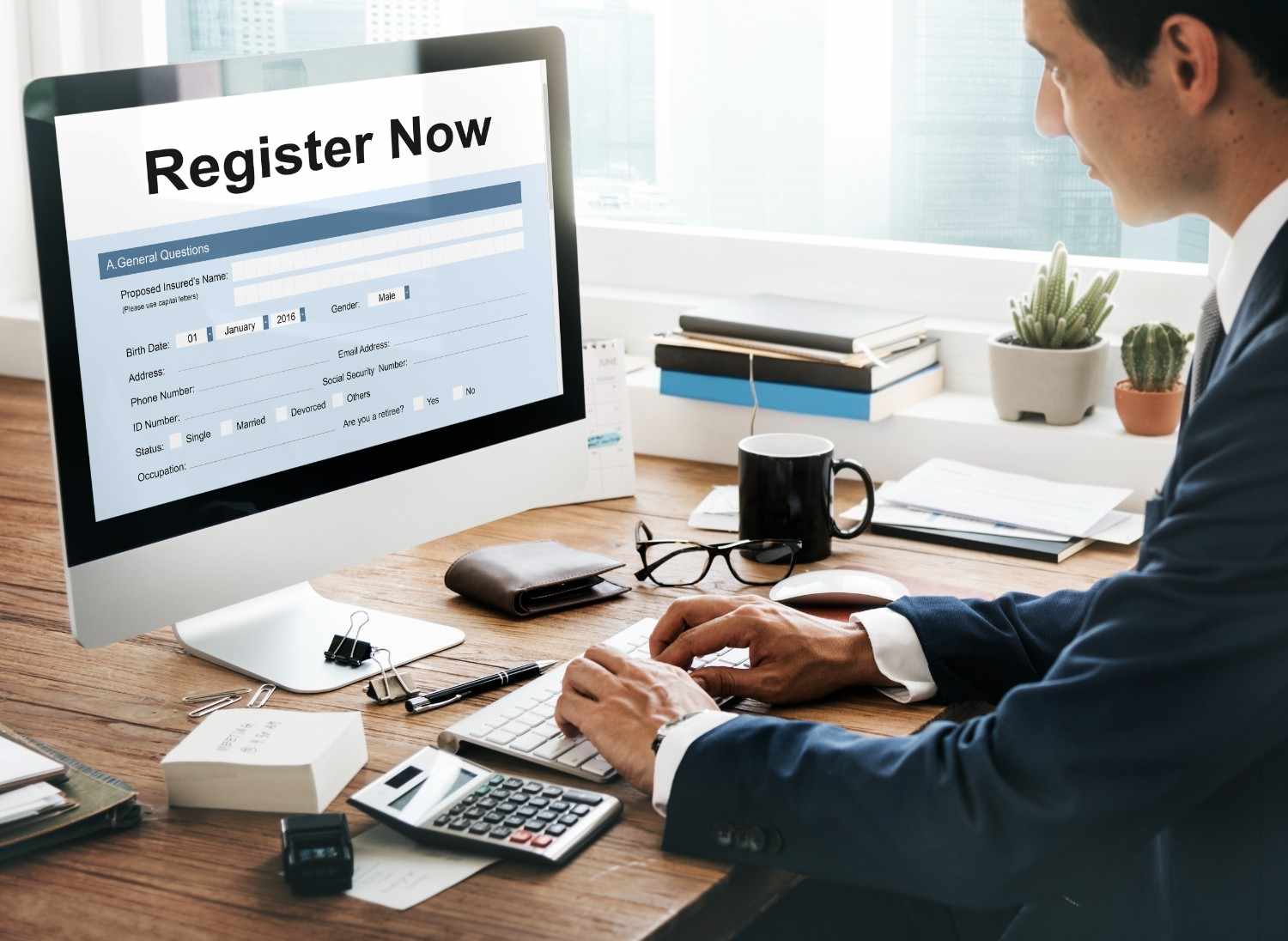 Business professional registering for FY 2026 H-1B visa process on computer, with registration form visible