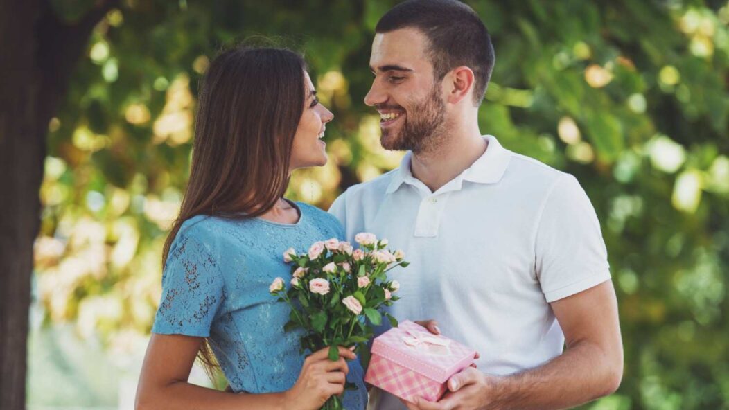 A couple celebrating prom with a "Prom Queen" sign, representing the complexities of marriage validity in U.S. immigration law.
