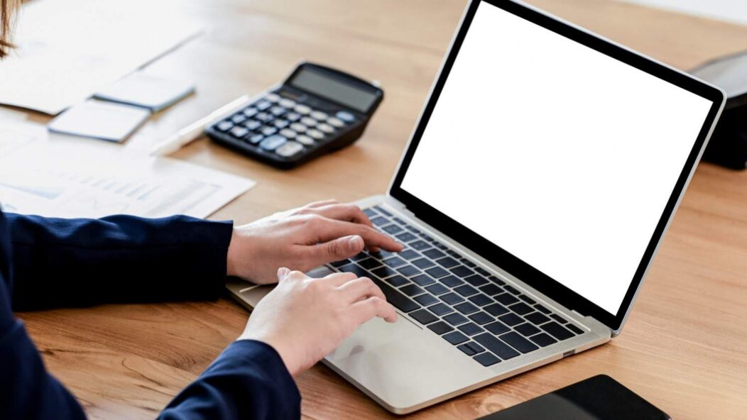 Business professional completing the 2025 U.S. Alien Registration online form on a desktop computer, ensuring compliance with new immigration requirements.