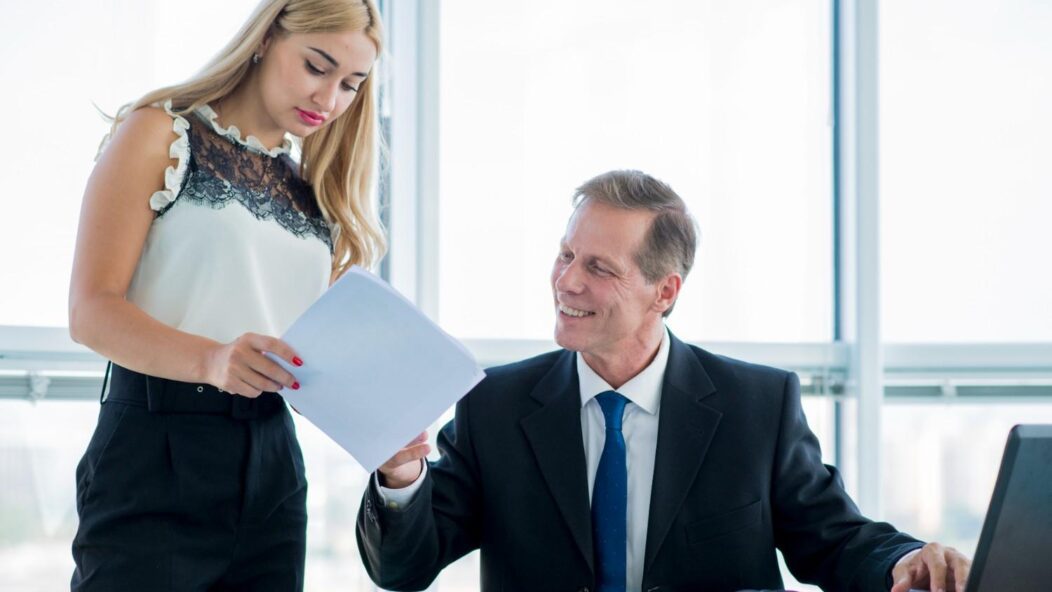 Immigration attorneys reviewing documents together in an office setting, highlighting the importance of legal strategies in securing U.S. visa approvals.