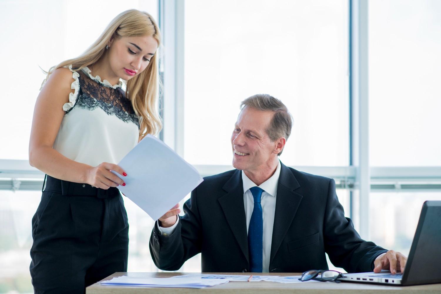 Immigration attorneys reviewing documents together in an office setting, highlighting the importance of legal strategies in securing U.S. visa approvals.