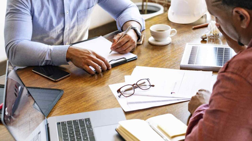 H-1B visa holder submitting passport during immigration consultation with attorney