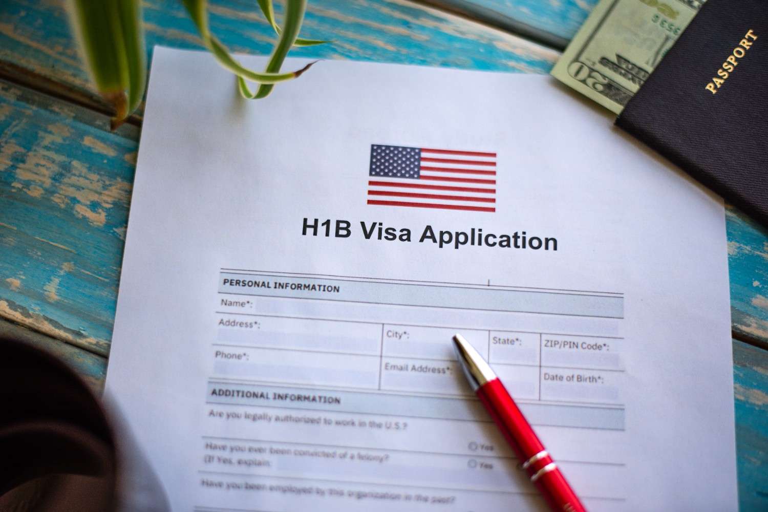 H-1B visa denial appeal process – A U.S. Green Card on a notebook with an American flag, pen, and laptop, symbolizing legal options for challenging denials.