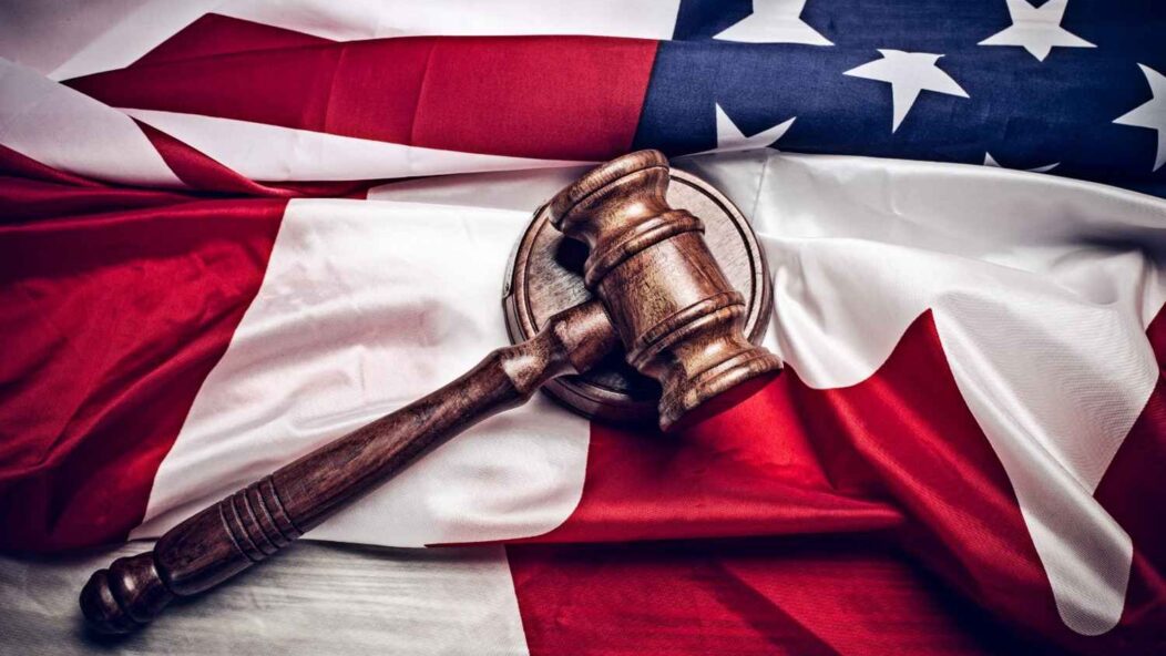 Motion to Dismiss immigration case strategy with judge's gavel on U.S. flag background.