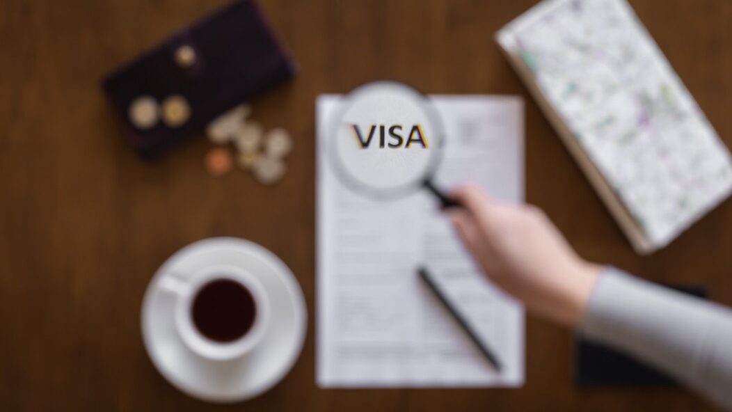 Magnifying glass highlighting the word VISA on legal documents – Visa Revocation Legal Help