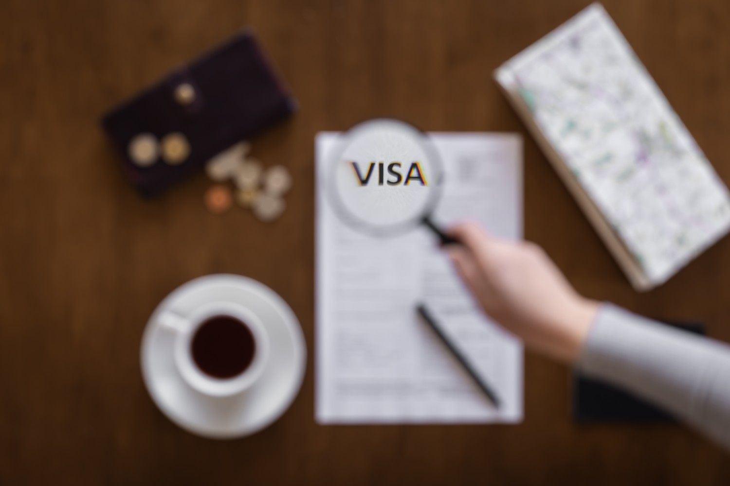 Magnifying glass highlighting the word VISA on legal documents – Visa Revocation Legal Help