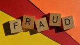 Challenge DHS fraud finding visa denial concept with wooden letter tiles